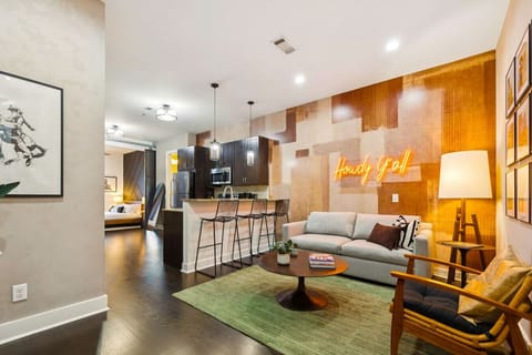 Stylish open concept living and dining spaces with Smart TV and sofa bed