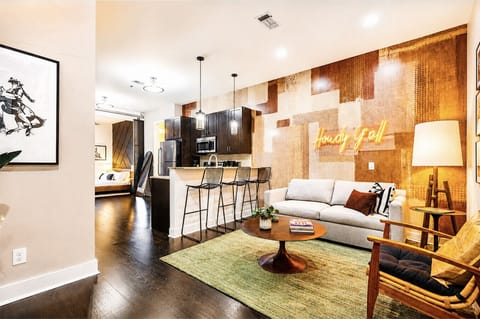 Stylish open concept living and dining spaces with Smart TV and sofa bed