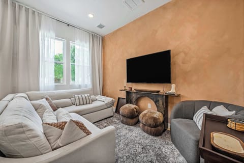 Living room with big TV, sectional & natural light