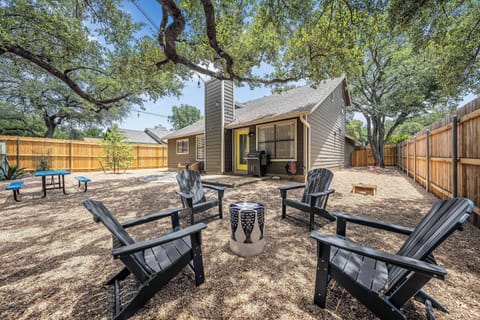 Back yard seating area view of gill area and picnic table 