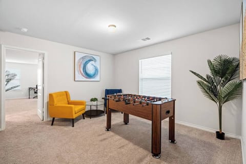 Cozy game room with a foosball table and comfy seating, perfect for family fun and relaxation. Located in a peaceful neighborhood, close to local attractions like the Fort Worth Zoo, Botanic Garden, and shopping areas. Ideal for long-term stays!