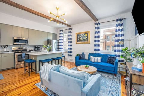 Enjoy a spacious open concept living room and kitchen with windows overlooking the iconic Broughton Street.