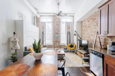 Stunning view of living room. Enjoy exposed brick walls and tall historic windows.