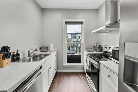 Large window bringing in natural light, creating a bright and welcoming cooking space.