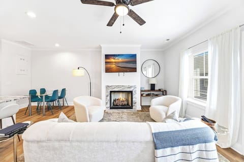 Sink into plush seating and unwind by the modern fireplace, with natural light streaming in from every angle.