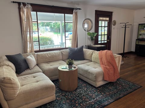 Alternate view of living room with front door in background