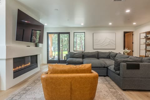 Living Room, Linear Gas Fireplace , Arm Chair, 77 Inch Smart TV, Deck With Patio Furniture and Gas BBQ, Half Bathroom