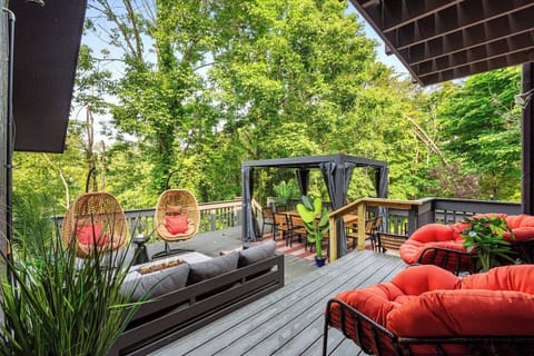 [Deck] ✨✨This spacious 1,000 ft deck is surrounded by lush trees.  Enjoy the gas BBQ and dine al-fresco - covered table seats up to 12 and has operable slats above. Lots of comfortable seating and a gas fire table will add to your enjoyment.✨✨
