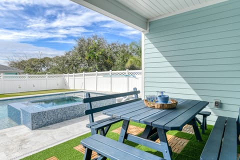 Enjoy great conversation and delicious meals gathered around the large table under the covered patio.