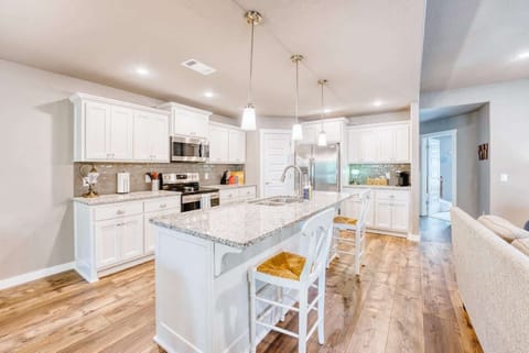 👩‍🍳 Chef’s kitchen with granite counters, stainless appliances & a large island opens to dining & living areas.