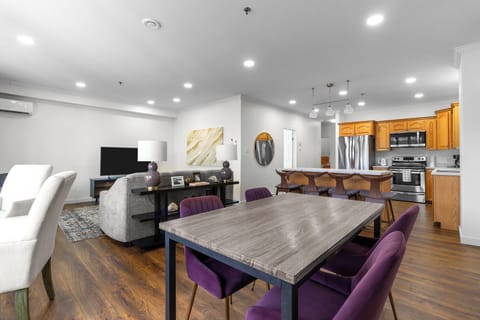 Modern open-concept living space with a cozy living room, stylish dining area, and fully equipped kitchen