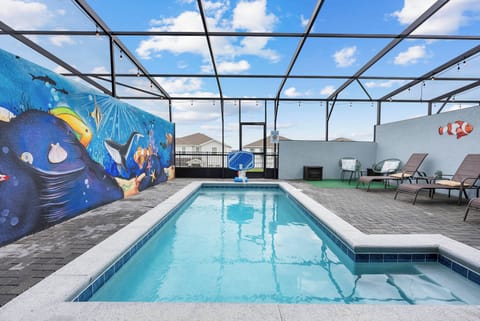Enjoy the sunshine by your private pool, framed by a vibrant mural that brightens your day. Relax on stylish loungers or take a refreshing dip, all within a spacious screened enclosure for your comfort.