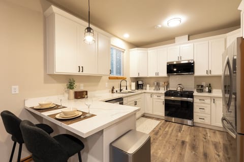 Well equipped kitchen, with two person seating at the kitchen island