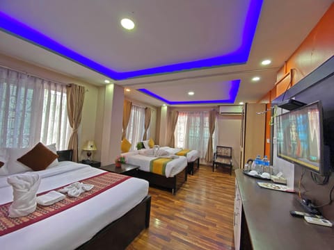 Deluxe Quadruple Room, City View | Desk, laptop workspace, soundproofing, free WiFi