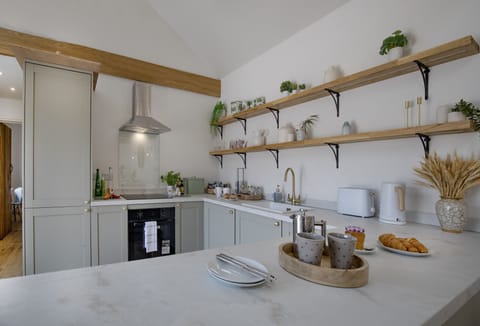 Woodsmoke, Taunton: Kitchen with an electric oven, induction hob, microwave, air fryer, fridge/freezer, dishwasher, washing machine, and a coffee machine
