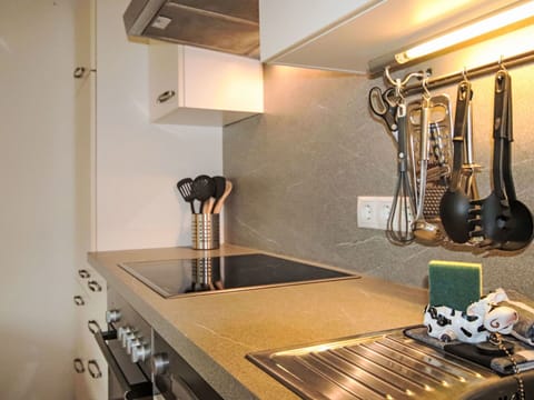 Kitchen, Countertop, Interior Design, Kitchen Appliance, Lighting, Light Fixture, Kitchen Stove, Cabinetry, Home Appliance, Plumbing Fixture