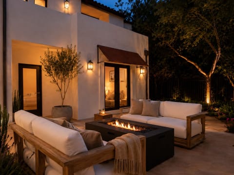 Exterior patio off of bedrooms with couches and fire pit