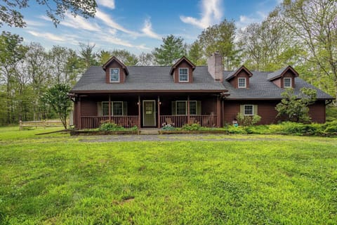 Charming country cabin surrounded by lush greenery, offering a peaceful family retreat.
