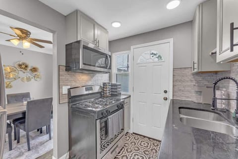 - Fully equipped kitchen with stainless steel stove   - Modern backsplash and stylish patterned flooring   - Easy access to dining area for home cooked meals  