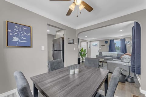 - Dining room with table seating for family meals   - Open layout connects to living room and kitchen   - Comfortable chairs and warm lighting for gatherings  