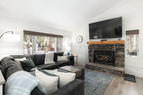 Cozy up to the fireplace, 75" TV, and Lovesac with two recliners!