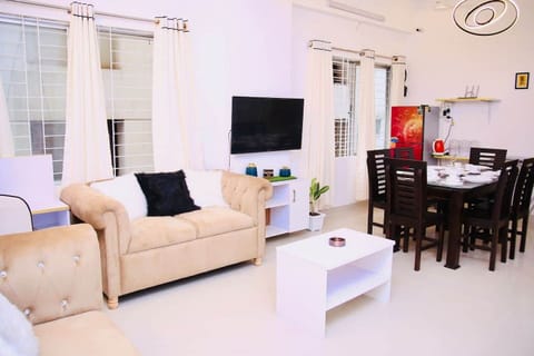 Spacious living cum dining area designed for comfort and connection. Ideal for relaxing, working, or enjoying meals, with ample seating, natural light, and a modern aesthetic that complements the entire apartment