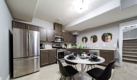 Modern full kitchen with stainless steel appliances and a cozy dining area, perfect for family meals and cooking together.