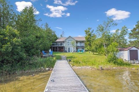 View from the dock looking back at the cottage — just steps from the water’s edge.