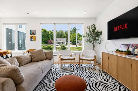 Living Room: Bright and comfortable living area featuring a cozy couch and smart TV, perfect for movie nights or quiet downtime.