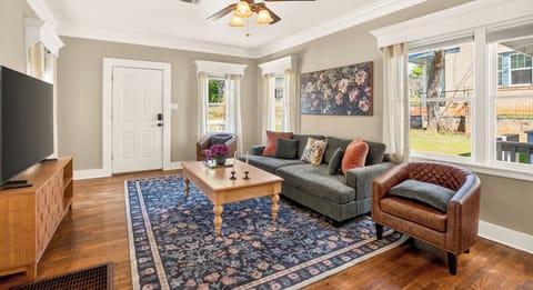 Warm wood floors, big windows & a couch that hugs back