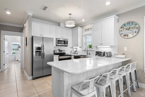 Sleek and stylish kitchen featuring a spacious island with bar seating for casual dining.