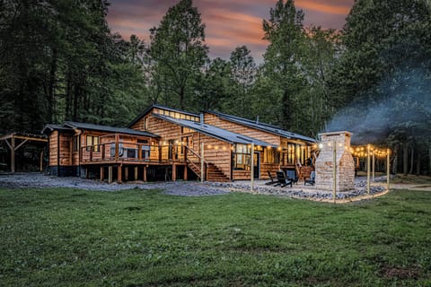 Fire chimney, hot tub, and lighted decks make the cabin spectacular at night