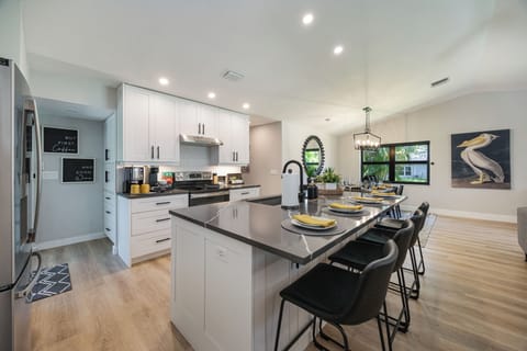 Large island with breakfast bar; dining table beside for easy family meals.