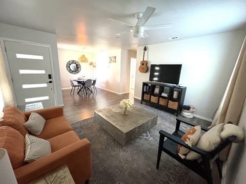 Cozy living room with plush seating and a large TV for movie nights or relaxing afternoons.