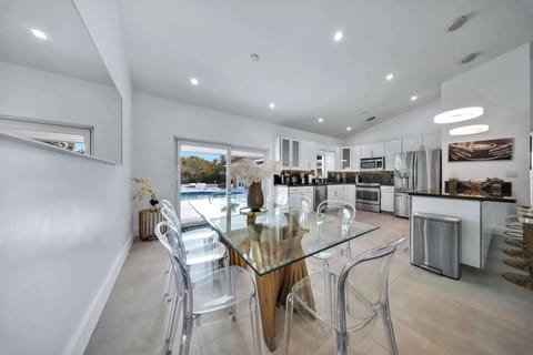 Modern, fully equipped kitchen connected to a stylish dining space