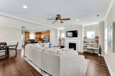 Living room with view of dining and kitchen.