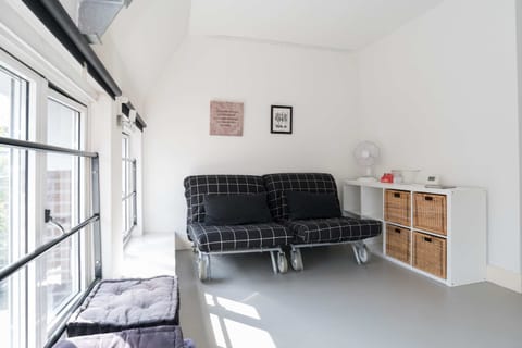 Bright and spacious with high ceilings, a sitting area, and characteristic windows.
