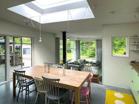 Open-plan design with kitchen overlooking living room.