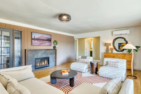 Living room with comfortable seating, TV, and a cozy fireplace.