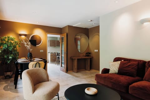 Open-plan living area with neutral tones and natural textures for a calming Japandi feel.