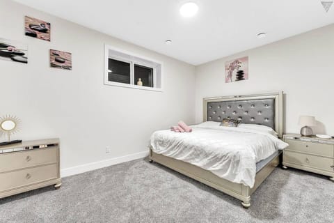 Indulge in a king bedroom with soft linens, fresh towels, side tables, and large windows for a serene retreat.