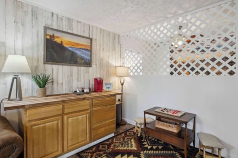 Bedroom 1 with king bed, smart TV, sofa bed, coffee bar, and ensuite bath