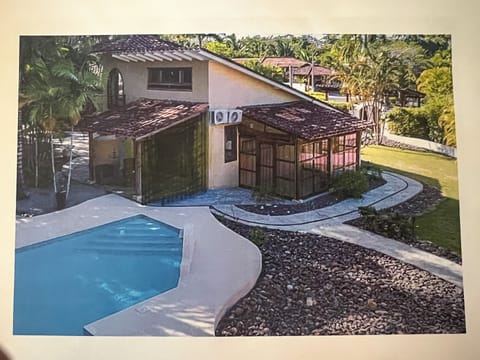 Pool, solarium, primary bedroom with covered patio