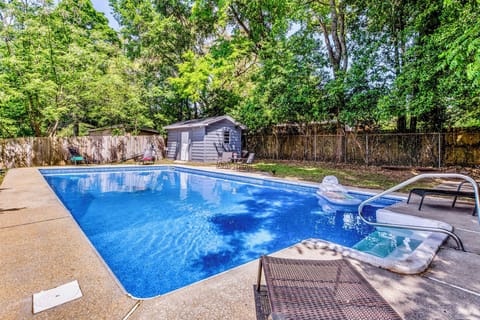 Backyard Oasis: Dive into relaxation in the expansive saltwater pool surrounded by lush greenery!.  Saltwater pool, not heated. 
