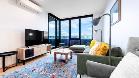 Sunlit living space with skyline views and cozy modern touches