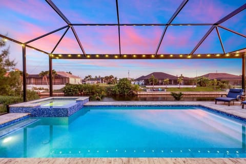 Unwind in the sparkling heated pool and spa with ambient string lighting and serene water views — pure vacation bliss