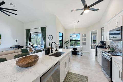 Open floor concept kitchen area w/ living area and pool views