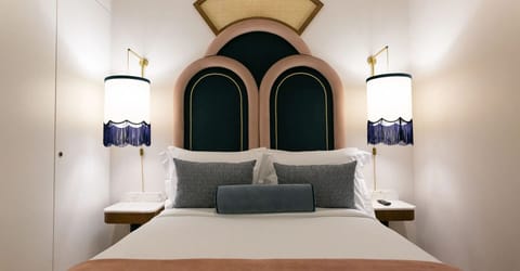 Sink into crisp sheets framed by elegant bedside lighting.