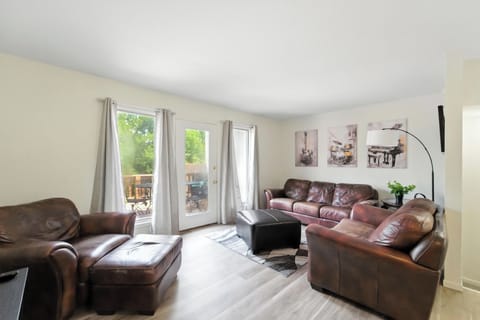 Comfy couches with a TV and access to the private deck.