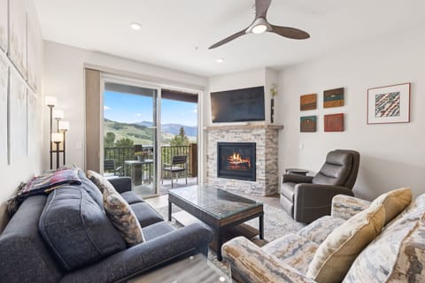 Spacious living area with gas fireplace and smart TV.